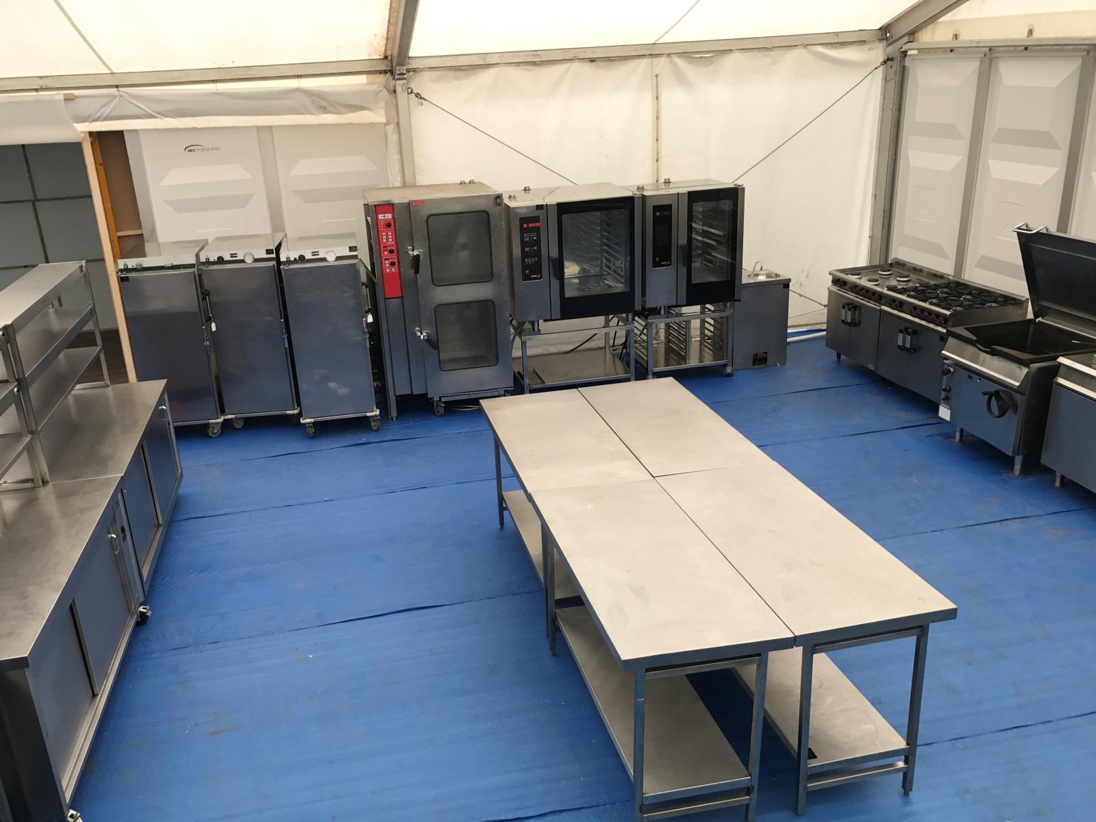 Marquee commercial events kitchen for a large sporting event with prep, production, refrigeration and servery.